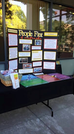 Picture of a display table with People First information and disability awareness information